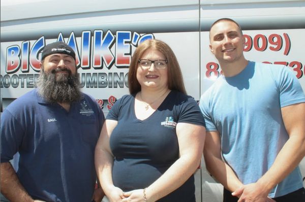 Three members of the Cortez family standing in front of a Big Mike's Rooter and Plumbing service truck in Yucaipa, California